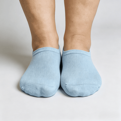 Light blue diabetic no-show socks with silicone heel grip strip and non-restrictive fit to prevent shifting while walking